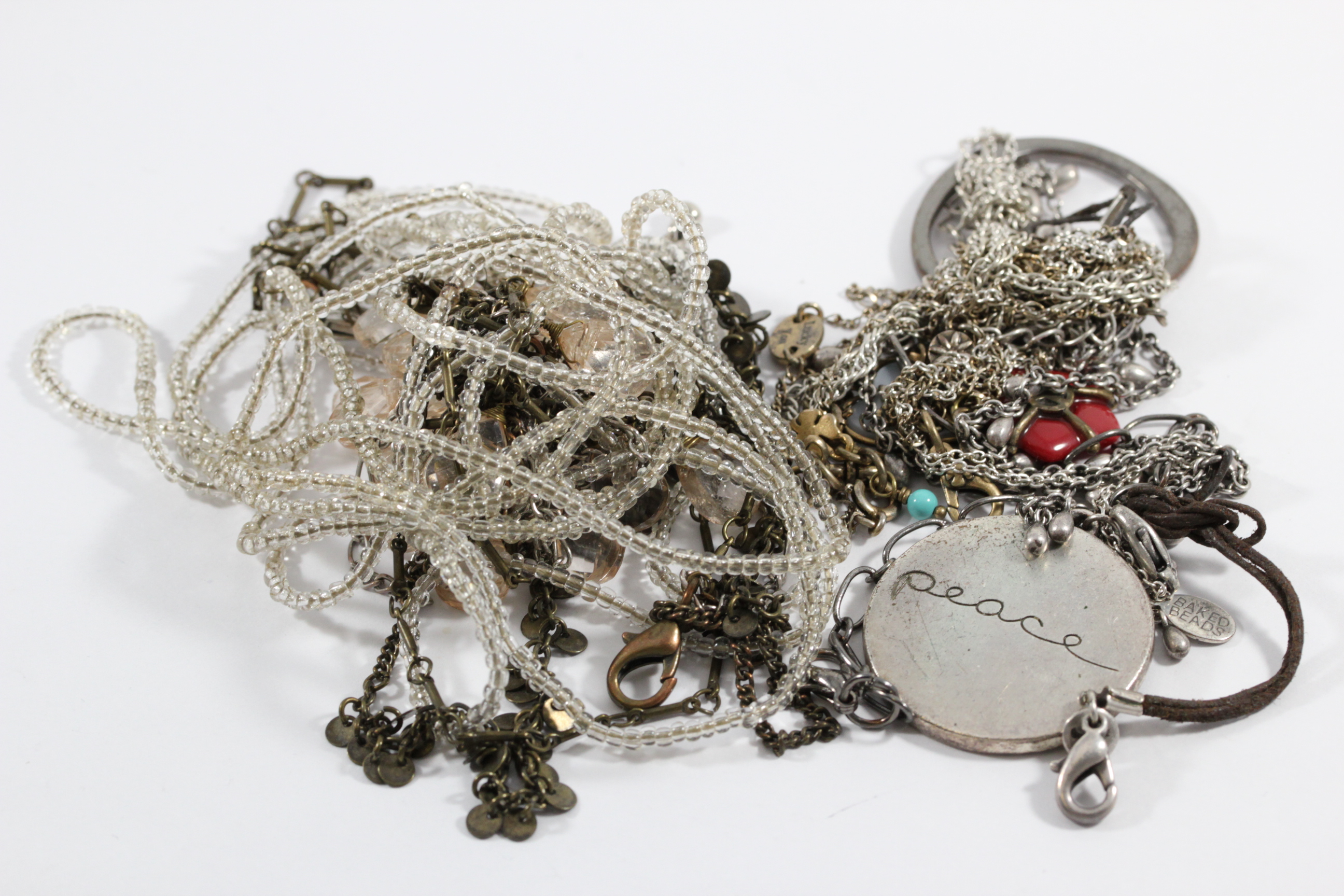 Tangled necklaces in a pile before untangling