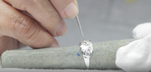Ring stones being checked under magnification