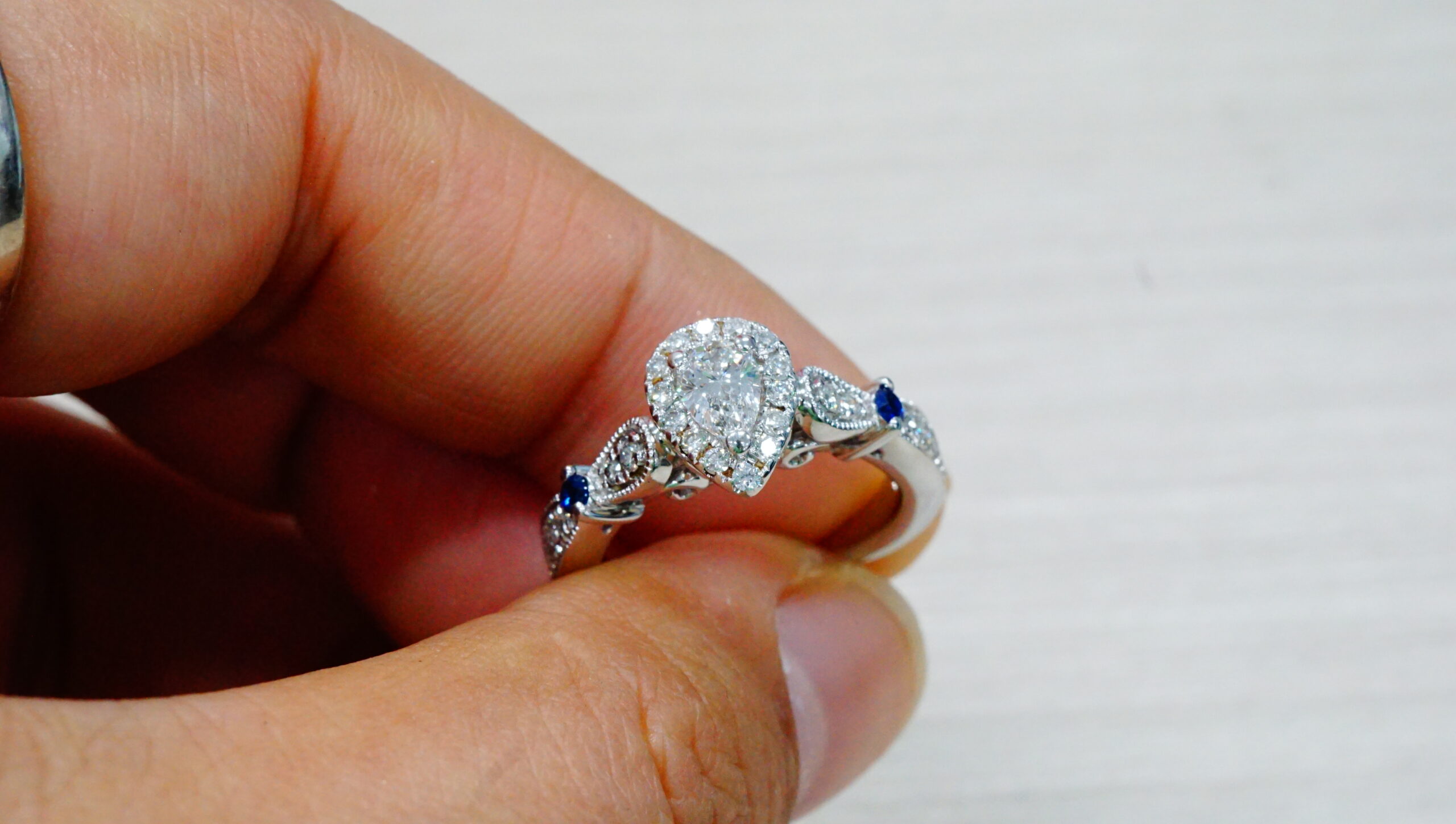 Halo ring held between fingertips